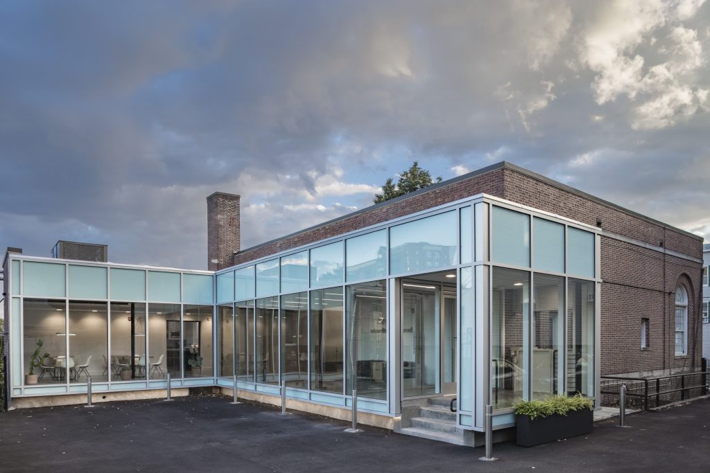 a building with glass walls and a brick wall
