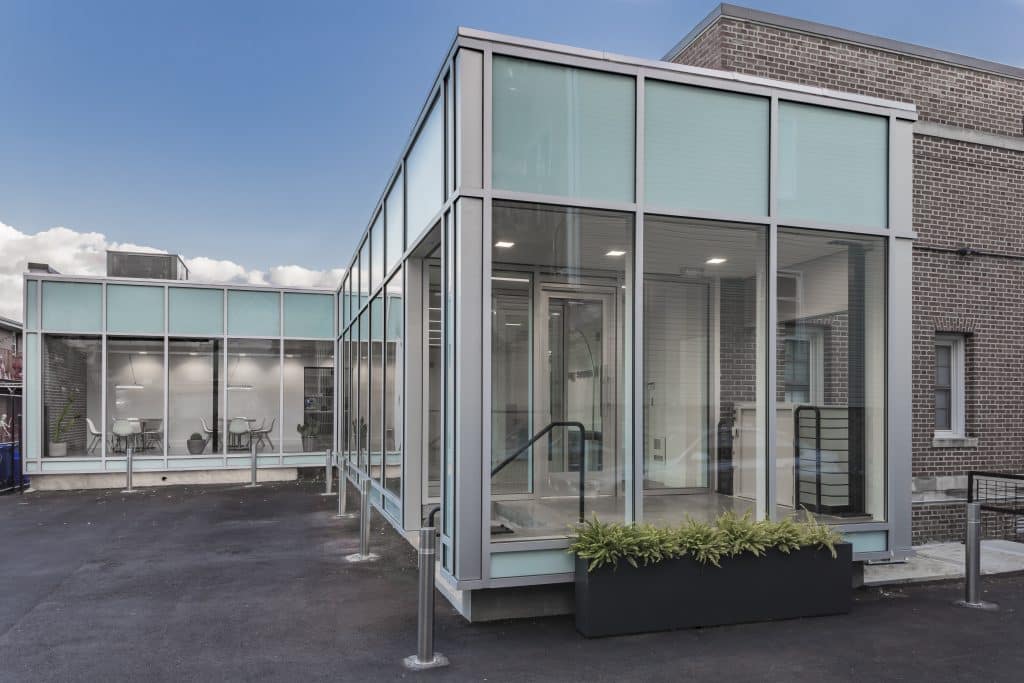 Shaoul Ohana a glass building with a staircase